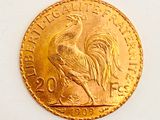 an image of a gold coin with a rooster on it