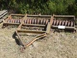 an old machine that is laying in the grass