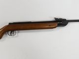 a rifle on a wall with a white background