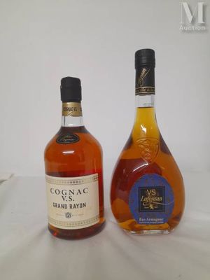 two bottles of cognac and a bottle of brandy on a table