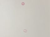 three pink circles on the white surface of a white wall