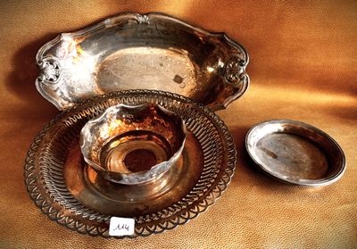 a silver plate and a silver bowl on a table