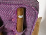 a wooden stick sticking out of the back of a chair