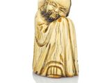a gold figurine of a man with a beard and a hat