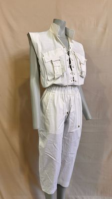 an image of a mannequin dressed in a white jumpsuit on a mannequin stand