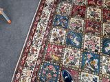 a person standing on a rug with a pair of blue shoes