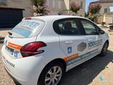 a small white car parked in front of a building