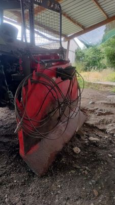 a tractor that is parked in the dirt