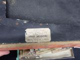 a person holding a piece of luggage that has a label on it
