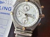 une montre en argent et en or posée sur une table à côté d'un ticket de caisse