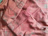 an image of a red and blue scarf laying on top of a bed
