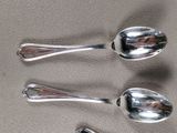 three spoons that are sitting next to each other on a table
