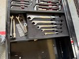 a lot of tools in a tool box on the floor