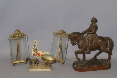 a statue of a man riding a horse next to a mirror