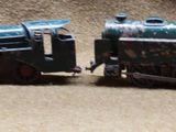 three toy trains sitting side by side on a table