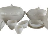 a picture of a white table setting with a tea pot and cups