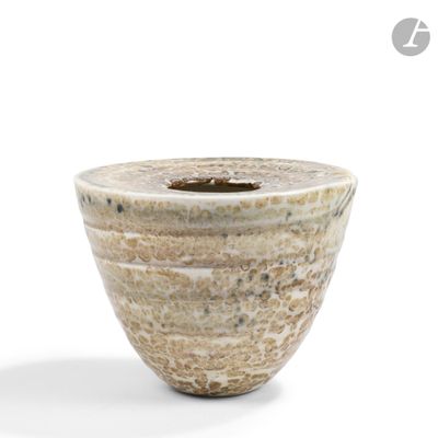 a white and brown vase sitting on a white surface