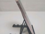 a cell phone on a stand on a white table
