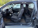 the interior of a car with the door open and the driver ' s seat up