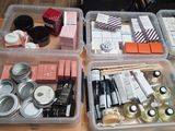several plastic containers filled with different types of cosmetics and makeup products