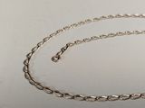 silver plated chain with a clasp on a white surface