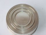 a silver container with a lid on a white table