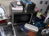 a kitchen with a microwave, toaster, toaster, and other items on the counter