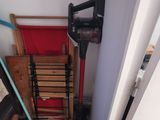 a red chair in the corner of a room next to a mirror