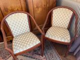 two chairs sitting next to each other on a rug