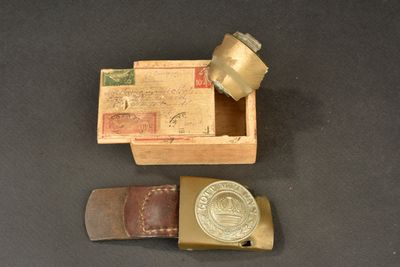 a small wooden box with a metal object inside of it