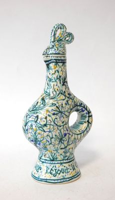 a blue and white vase with a bird on top of it