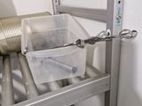 a metal shelf with containers and a can on it