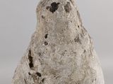 a stone bird that is sitting on a table