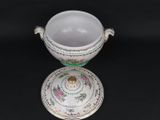 a white bowl with a green and pink design on it