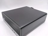 a close up of a small black computer on a white surface