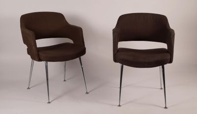 pair of brown chairs sitting next to each other on a white surface