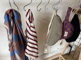 many coats hanging on a rack in a room
