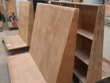several pieces of plywood are stacked on top of each other in a warehouse