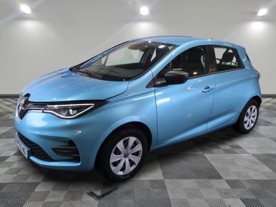 a blue car parked in a garage with a checkered floor