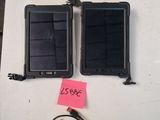 deux téléphones portables posés sur une table, avec un mot accroché dessus