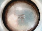 a close up of a vase with a small square in it