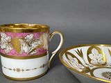 two cups and a bowl are sitting side by side on a table