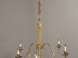 an antique brass chandelier with five arms and five lights