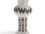 a white vase that is sitting on a white surface