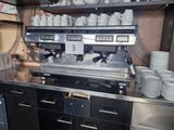 a coffee machine that is on a counter in a kitchen