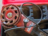 a red tool box with tools in it on the floor
