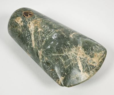 green marble cylinder with a hole in the middle on a white surface