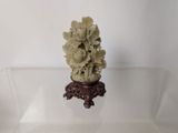 a small vase with flowers in it on a glass table
