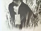 an old black and white photo of a woman in a field