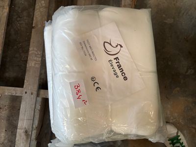 a bag of white toilet paper sitting on a pallet